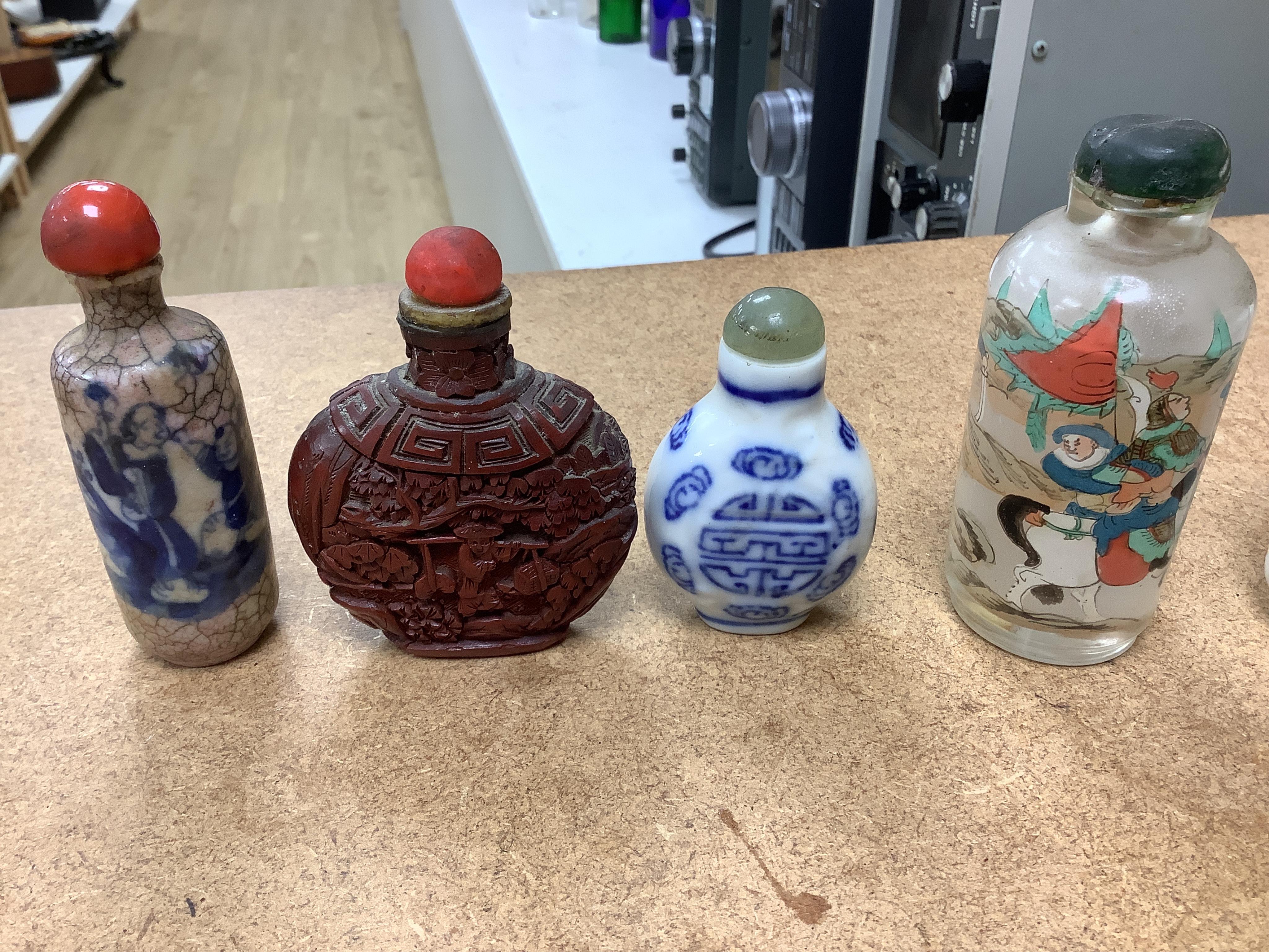 A small collection of Chinese snuff bottles, 19th century and later to include reverse glass painted examples and cinnabar lacquered examples, largest 9.5cm high